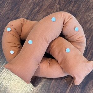 Handmade Brown Pretzel-Shaped Pillow with PomPom Accents